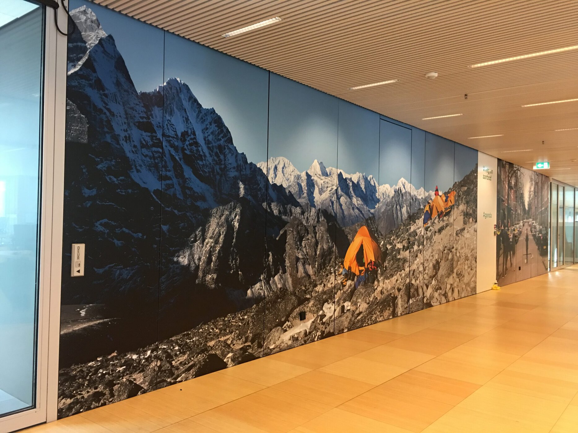 a wall with a picture of mountains and a yellow tent